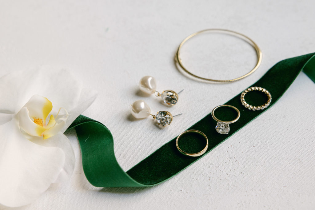 styled bridal jewelry with green ribbon